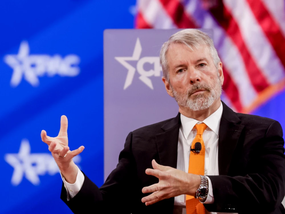 Michael Saylor speaking on stage at a conference.